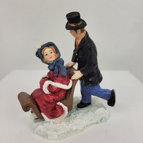 Mervyns 1997 Christmas Village Square Figurine Accessory Man Woman Sled 4" x 3" - Picture 1 of 6
